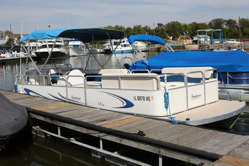 Slide: The Image of 2007 Sundancer Pontoons 24LX docked with blue canopy and spacious seating. - 2