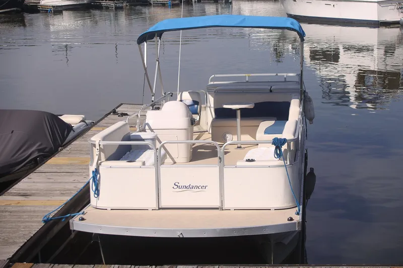 Slide: The Image of 2007 Sundancer Pontoons 24LX docked at marina, featuring spacious seating and canopy. - 3