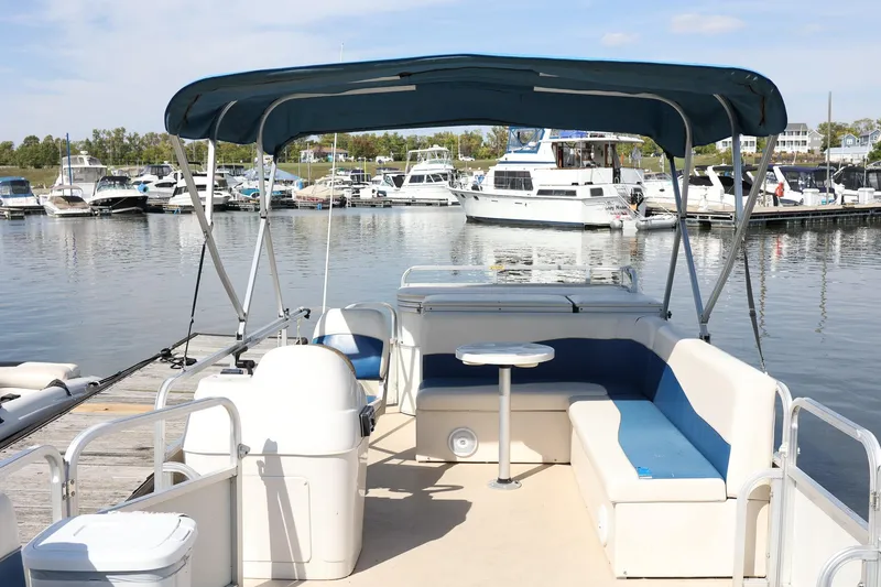 Slide: The Image of 2007 Sundancer Pontoons 24LX at marina, featuring spacious seating and canopy. - 6
