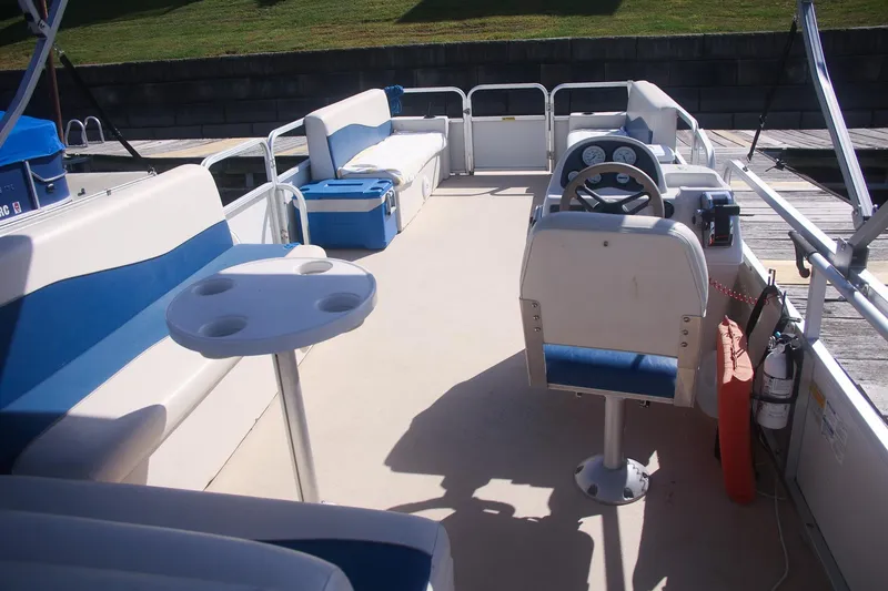 Slide: The Image of 2007 Sundancer Pontoons 24LX interior with seating, steering wheel, and table. - 9