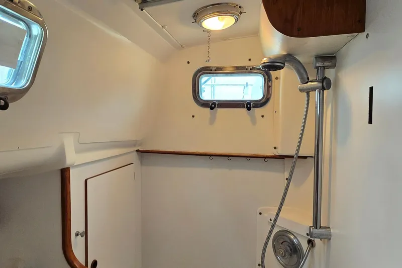 Slide: The Image of Interior of 1997 Freedom 35 sailboat bathroom with shower and porthole window. - 12