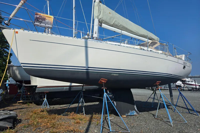 Slide: The Image of Sailboat Freedom 35, 1997 model, on stands in a boatyard under clear blue sky. - 16