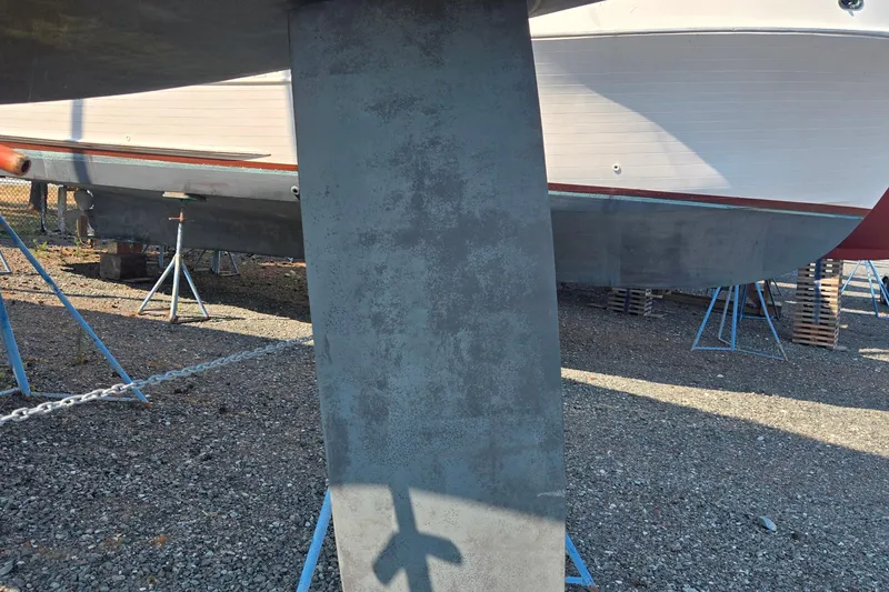Slide: The Image of 1997 Freedom 35 sailboat keel and hull on stands in a boatyard. - 17