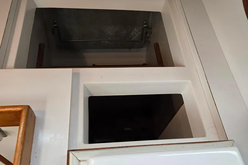 Slide: The Image of Interior view of a 1997 Freedom 35 sailboat, featuring storage compartments. - 7