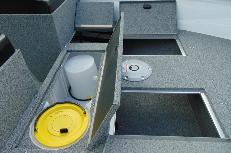 Slide: The Image of 2026 Crestliner 1650 Kodiak boat storage compartments with open hatches and bucket. - 10