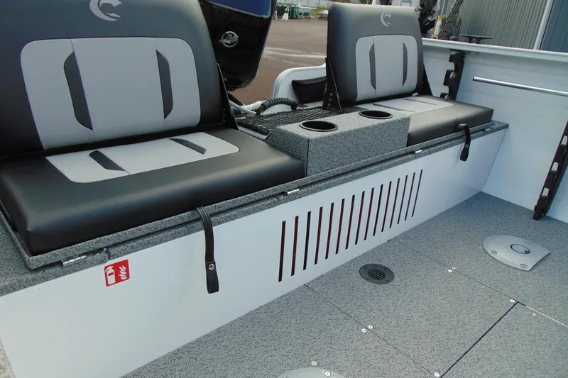 Slide: The Image of 2026 Crestliner 1650 Kodiak boat interior with cushioned seating and cup holders. - 12
