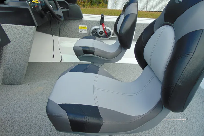 Slide: The Image of 2026 Crestliner 1650 Kodiak boat interior with gray and black seating. - 7