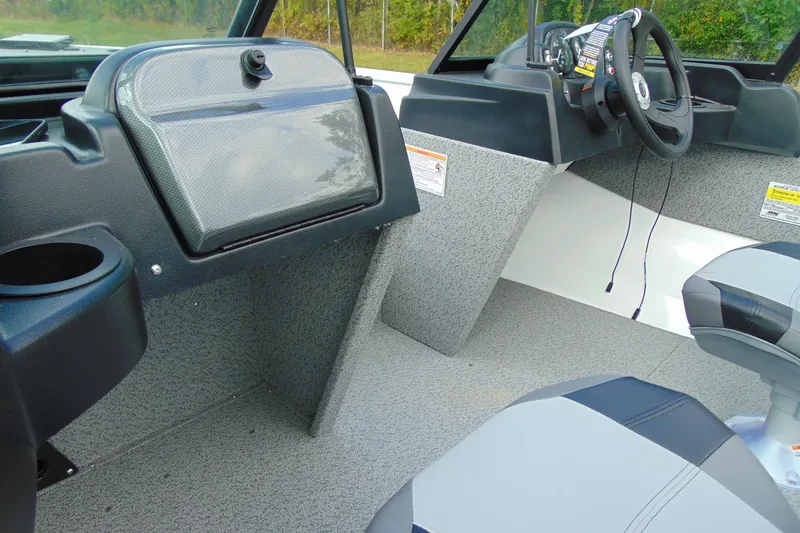 Slide: The Image of Interior of 2026 Crestliner 1650 Kodiak boat, featuring steering console and seating. - 8