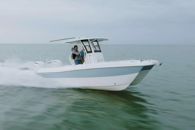 Slide: The Image of 2026 World Cat 235TE boat cruising on open water, showcasing sleek design and performance. - 0