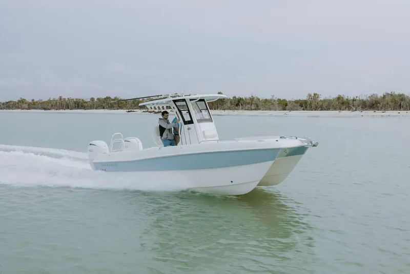 Slide: The Image of 2026 World Cat 235TE boat cruising on calm waters. - 12