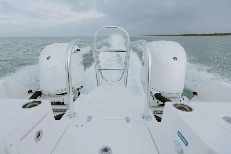 Slide: The Image of 2026 World Cat 235TE boat with dual engines cruising on open water. - 13