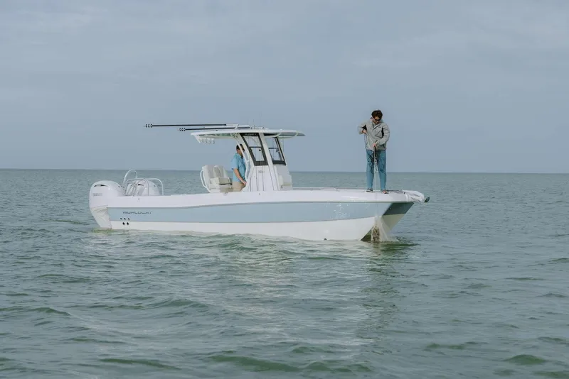 Slide: The Image of 2026 World Cat 235TE boat on calm water with two people onboard. - 18