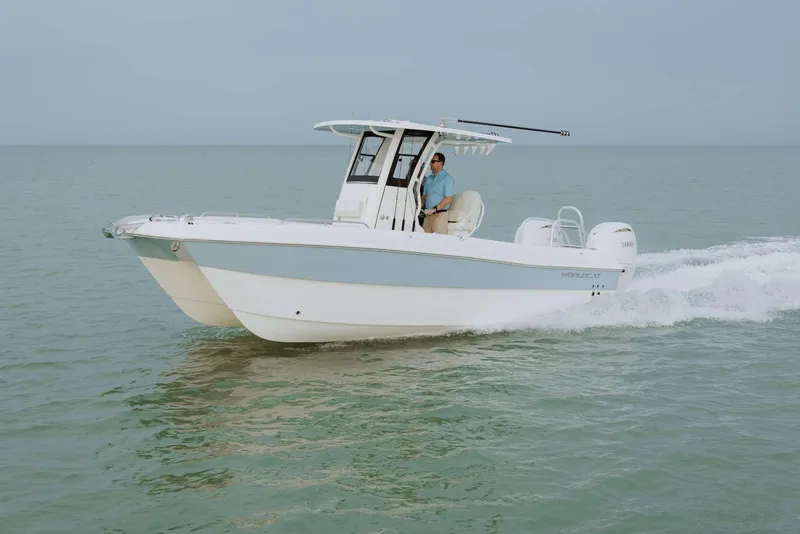 Slide: The Image of 2026 World Cat 235TE boat cruising on open water. - 2