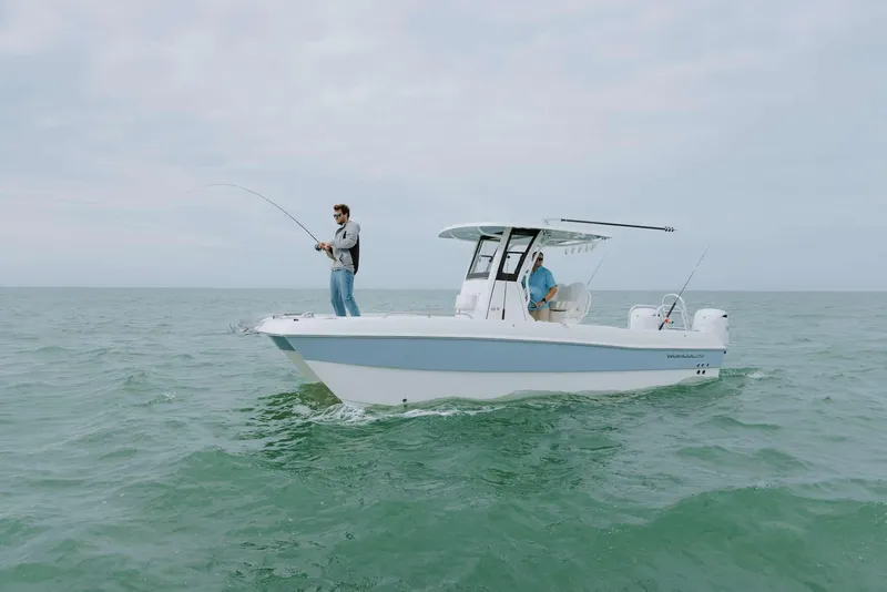 Slide: The Image of 2026 World Cat 235TE boat with people fishing on open water. - 21