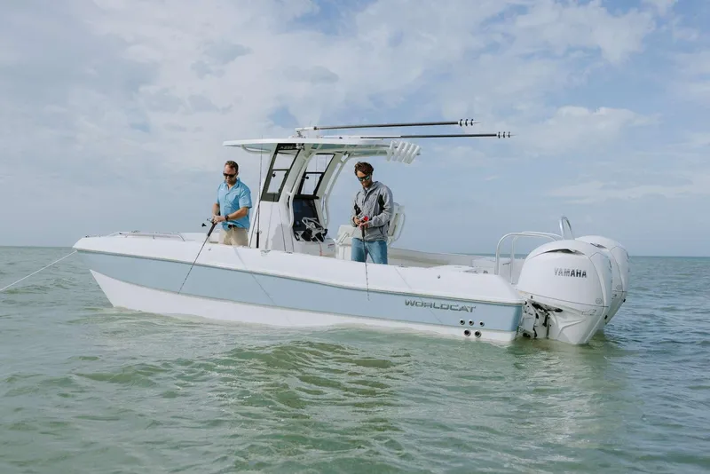 Slide: The Image of 2026 World Cat 235TE boat with two people fishing in calm waters. - 22