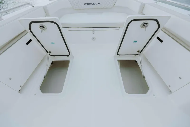 Slide: The Image of 2026 World Cat 235TE boat deck with open storage compartments. - 32