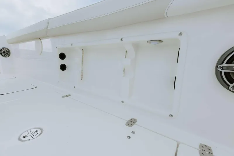 Slide: The Image of 2026 World Cat 235TE boat interior with storage compartments and speaker. - 42