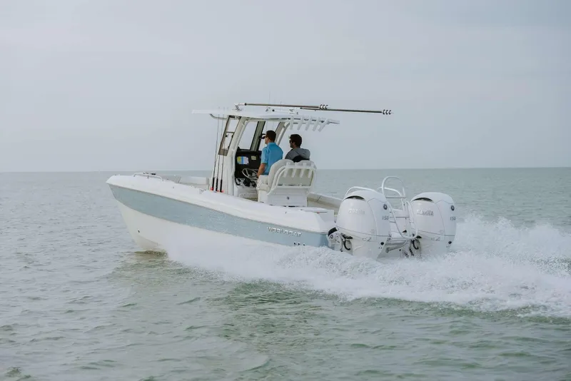 Slide: The Image of 2026 World Cat 235TE boat cruising on open water with two passengers. - 9