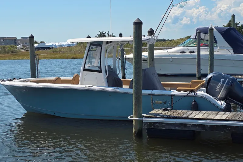 Slide: The Image of 2019 Sea Hunt Ultra 255 SE boat docked with Yamaha engine. - 0
