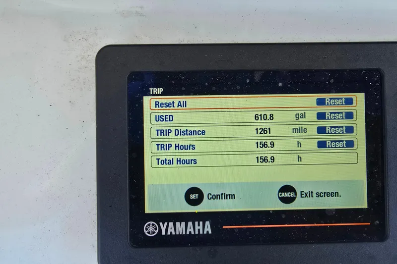 Slide: The Image of 2019 Sea Hunt Ultra 255 SE boat docked at marina with tan seating and steering wheel. - 13