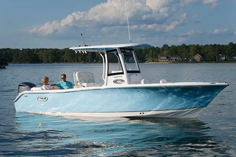 Slide: The Image of 2019 Sea Hunt Ultra 255 SE boat interior with tan seating and storage compartments. - 15