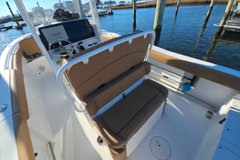 Slide: The Image of 2019 Sea Hunt Ultra 255 SE boat interior with helm and seating area. - 17