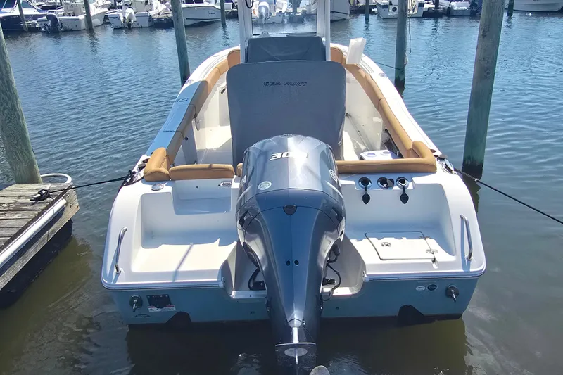 Slide: The Image of 2019 Sea Hunt Ultra 255 SE boat docked at a marina. - 2