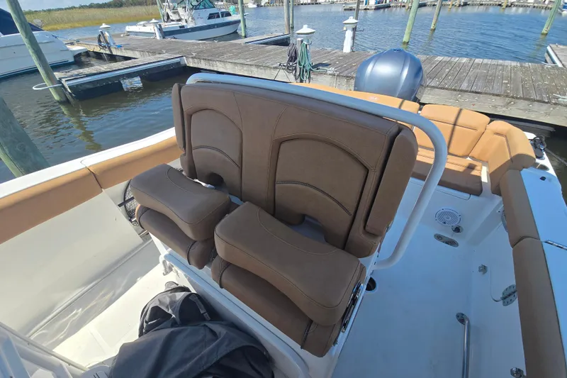 Slide: The Image of 2019 Sea Hunt Ultra 255 SE boat console with steering wheel and controls. - 6
