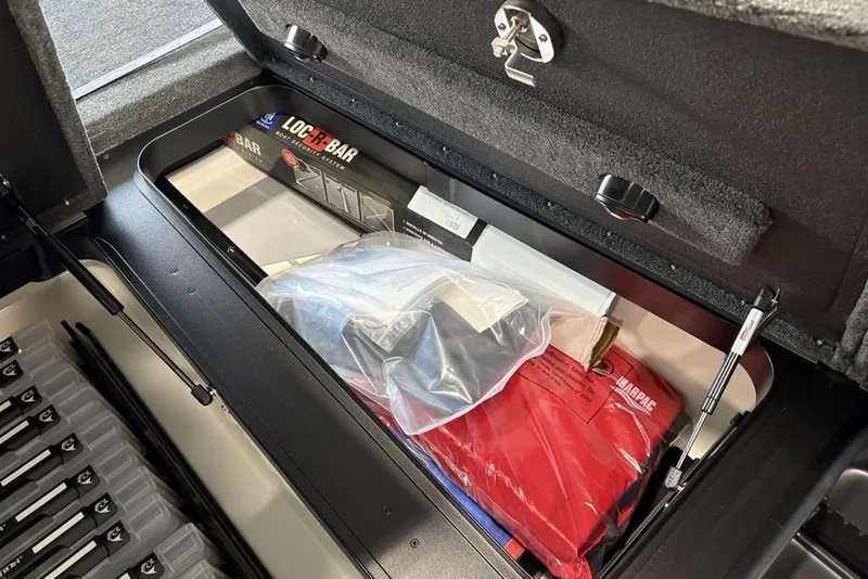 Slide: The Image of Storage compartment of 2026 Skeeter FXR20 Apex boat with accessories and equipment. - 11