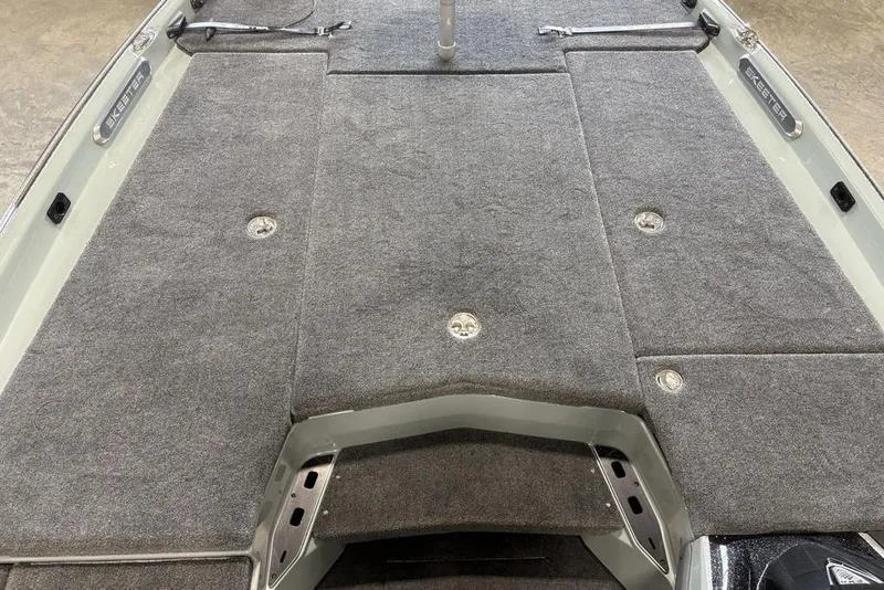 Slide: The Image of 2026 Skeeter FXR20 Apex boat deck with gray carpet and storage compartments. - 14