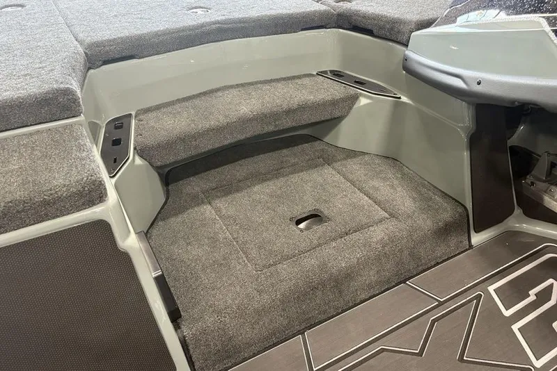 Slide: The Image of 2026 Skeeter FXR20 Apex boat interior with carpeted steps and storage compartment. - 15