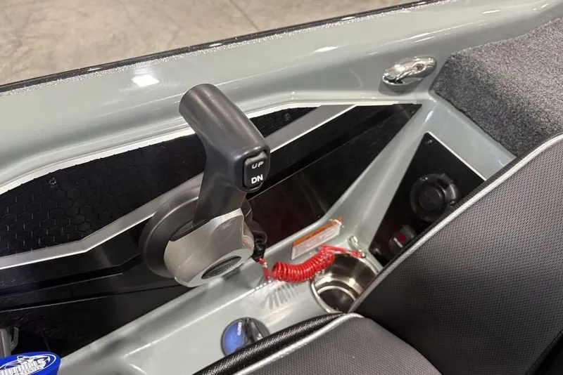 Slide: The Image of 2026 Skeeter FXR20 Apex boat control panel with throttle lever and cup holder. - 22