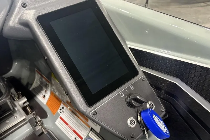 Slide: The Image of 2026 Skeeter FXR20 Apex dashboard with touchscreen and ignition key. - 27