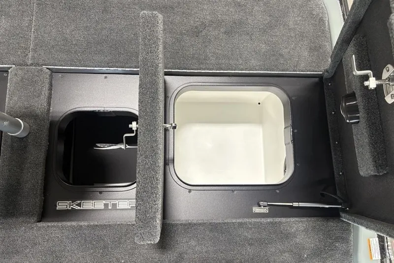 Slide: The Image of 2026 Skeeter FXR20 Apex boat storage compartments with carpeted interior. - 34