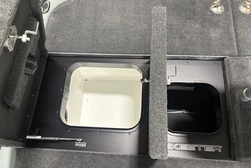 Slide: The Image of 2026 Skeeter FXR20 Apex boat storage compartments with carpeted interior. - 36