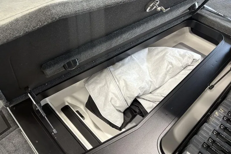 Slide: The Image of 2026 Skeeter FXR20 Apex storage compartment with cover inside, showcasing spacious design. - 9