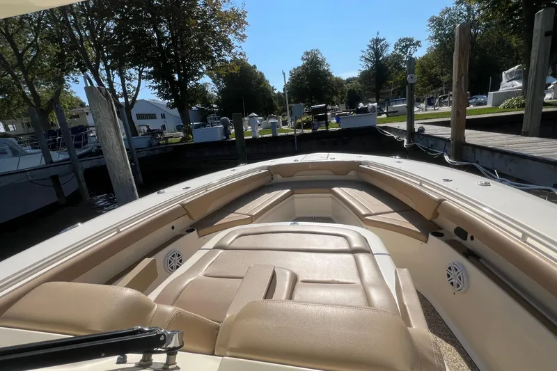 Slide: The Image of 2020 Scout 380 LXF boat interior with beige seating and docked at marina. - 14