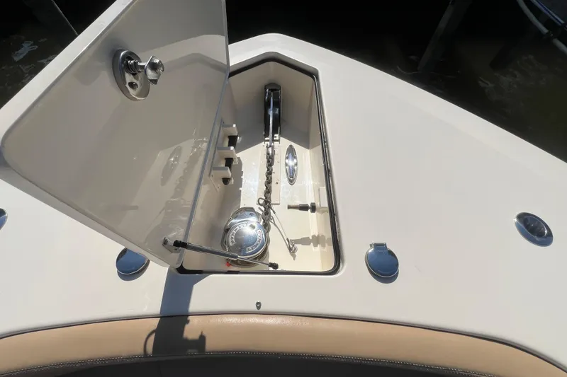 Slide: The Image of Anchor compartment of 2020 Scout 380 LXF boat, showcasing chain and winch system. - 16