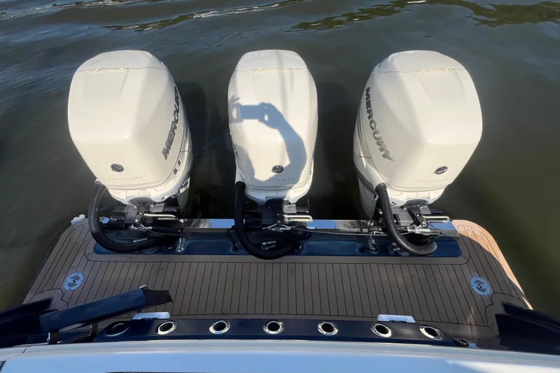Slide: The Image of 2020 Scout 380 LXF boat with triple Mercury outboard engines on water. - 20
