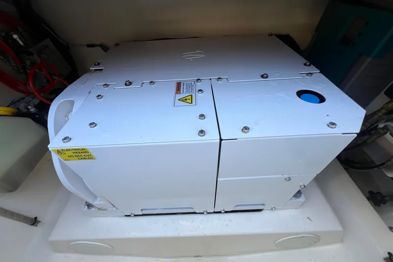 Slide: The Image of Electrical equipment inside 2020 Scout 380 LXF boat, featuring safety warning labels. - 26