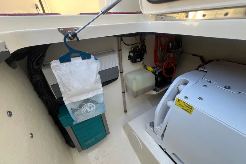 Slide: The Image of 2020 Scout 380 LXF boat interior showing electrical components and storage area. - 28