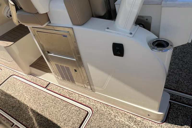 Slide: The Image of 2020 Scout 380 LXF boat interior with seating, storage, and cup holder. - 34