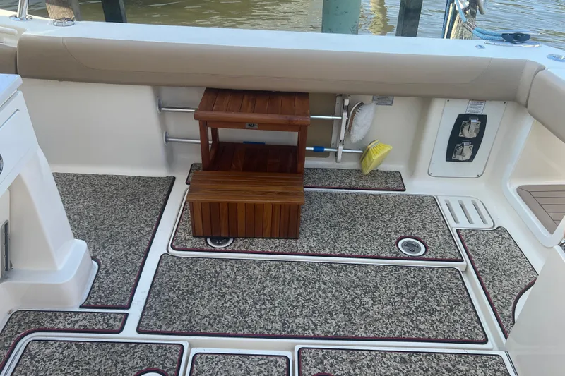 Slide: The Image of 2020 Scout 380 LXF boat interior with teak steps and textured flooring. - 41