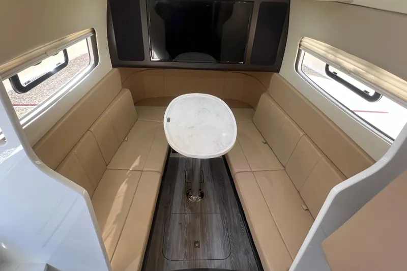 Slide: The Image of Luxurious interior of 2020 Scout 380 LXF boat with beige seating and a central table. - 44