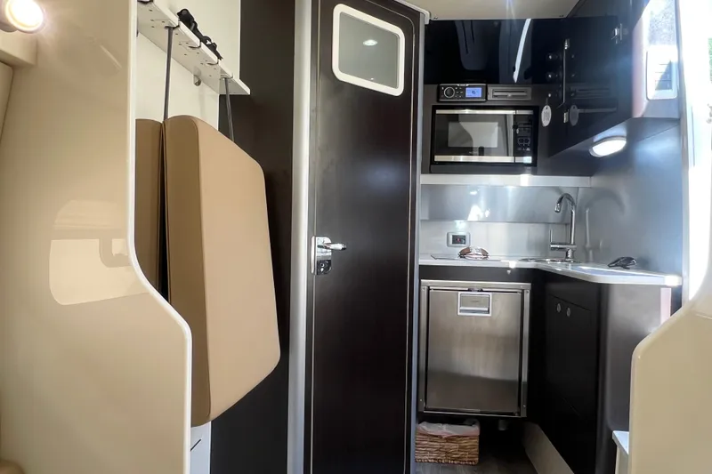 Slide: The Image of 2020 Scout 380 LXF interior with modern kitchenette, featuring microwave and sink. - 48