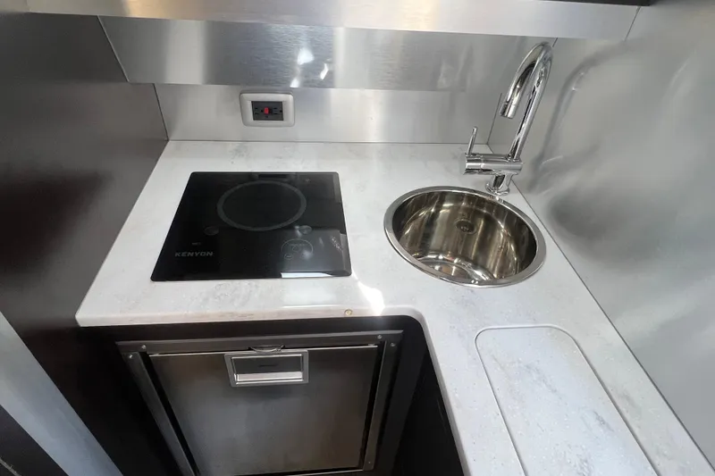 Slide: The Image of 2020 Scout 380 LXF boat kitchen with stove, sink, and countertop. - 53