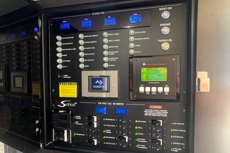 Slide: The Image of Control panel of a 2020 Scout 380 LXF boat with various switches and displays. - 54