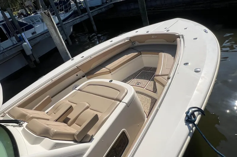 Slide: The Image of 2020 Scout 380 LXF boat with luxurious seating, docked at a marina. - 7