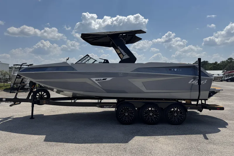 Slide: The Image of 2026 Tigé 24RZX boat on trailer under a sunny sky. - 5