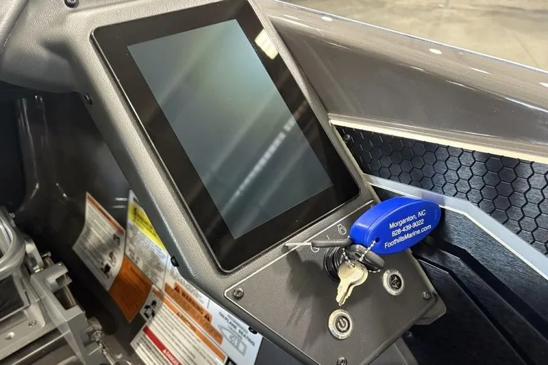 Slide: The Image of 2026 Skeeter FXR20 FLEX dashboard with touchscreen and ignition keys. - 21